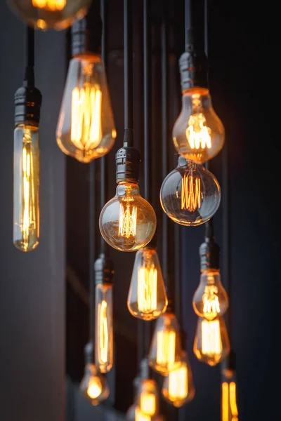 Diferent vintage tungsten filament lamps hanging from the ceilin