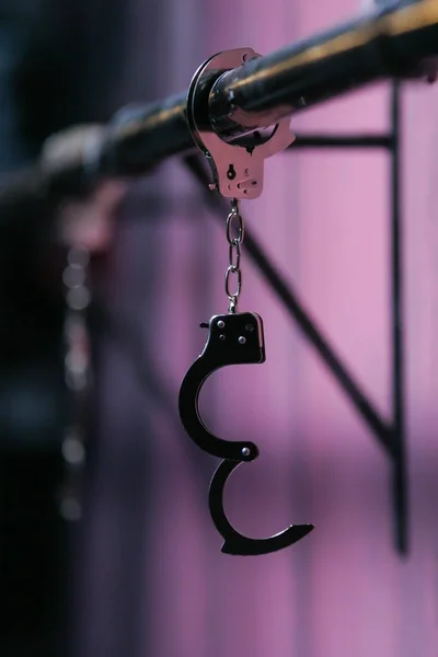 Police handcuffs hanging locked — Stock Photo, Image