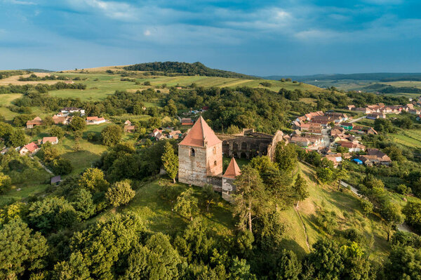 Aerial drone view of Slimnic Fortress (Stolzenburg), located on a Burgbasch hill on a Sibiu road in Transilvania, Romania. Travel spots in Romania