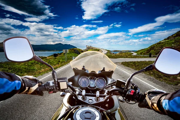 Biker rides a road with Atlantic Ocean Road in Norway. First-per — Stock Photo, Image