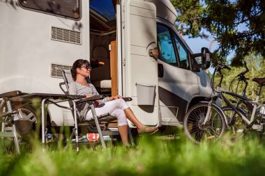 Woman resting near motorhomes in nature. Family vacation travel, clipart