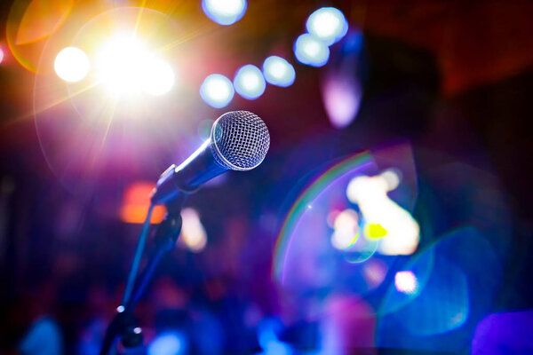 Microphone on stage against a background of auditorium.