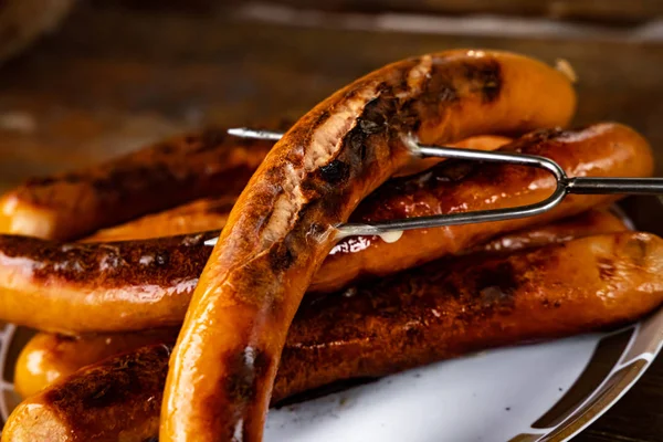 Grilled sausages on wooden board — Stock Photo, Image