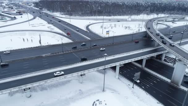 Aerial view of a freeway intersection Snow-covered in winter. — Stock Video