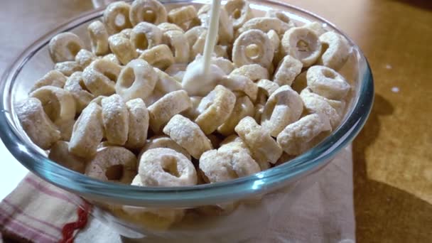 Knusprige Haferflocken in einer Schüssel für ein köstliches Frühstück mit Milch am Morgen. Zeitlupe mit Drehverfolgungsschuss. — Stockvideo