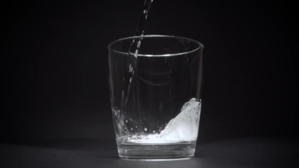 Eau minérale dans un verre transparent au ralenti 