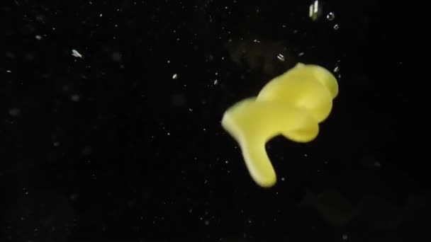 Паста фузилли падает в воду в замедленной съемке — стоковое видео