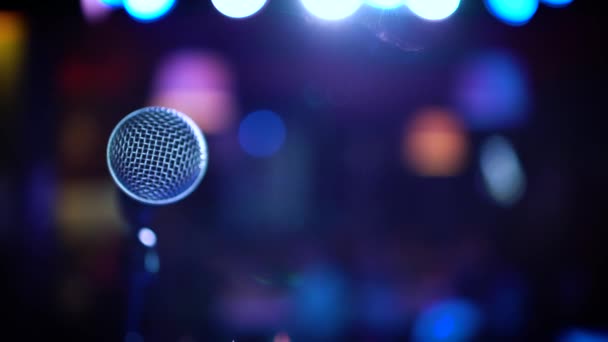 Micrófono en el escenario sobre un fondo de auditorio — Vídeos de Stock