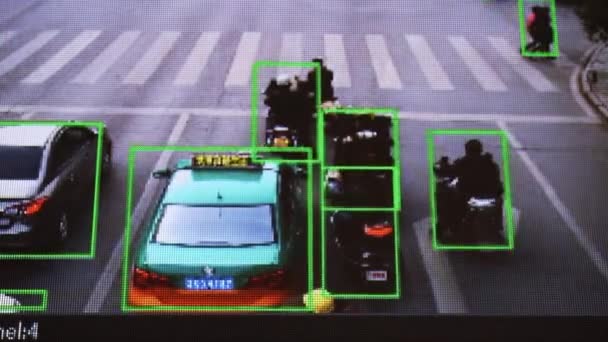 CCTV camera. Real-time tracking of vehicles and people on the street. Authentic pixelated image from a real monitor. — Stock Video