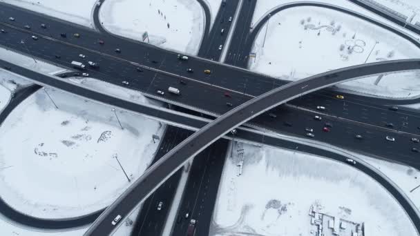 Aerial view of a freeway intersection Snow-covered in winter. — Stock Video