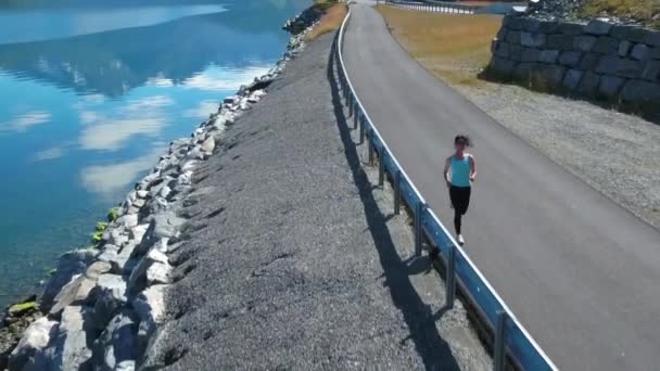 Kadın dışarıda koşuyor. Norveç fiyordu. — Stok video