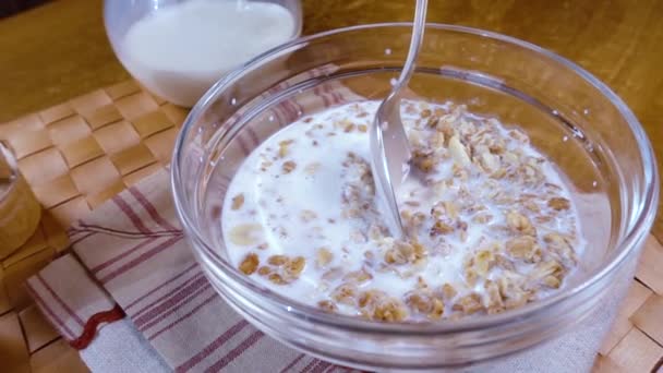 Celozrnné cereálie müsli v misce k snídani s mlékem. Zpomalený pohyb se snímkem sledování otáčení. — Stock video