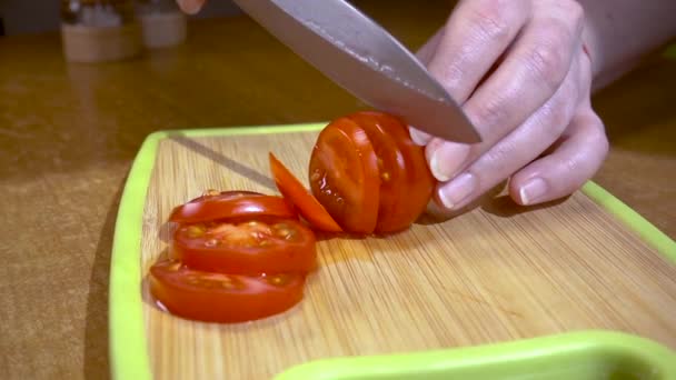 Knife cuts tomato on wooden board Slow motion with rotation tracking shot. — Stock Video