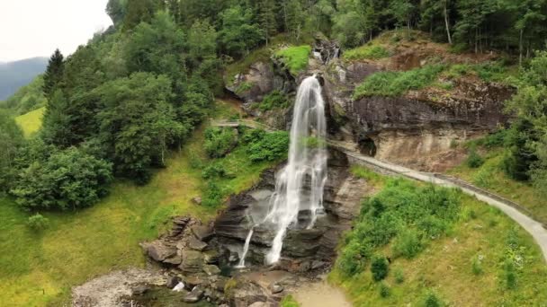 Steinsdalsfossen is a waterfall in the village of Steine in the municipality of Kvam in Hordaland county, Norway. The waterfall is one of the most visited tourist sites in Norway. — Stock Video