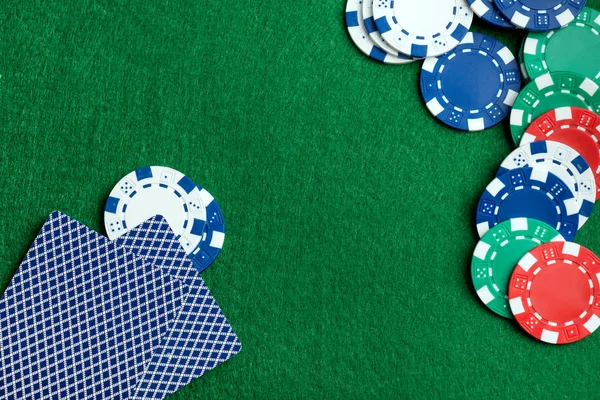 Casino green table with chips and play cards — Stock Photo, Image