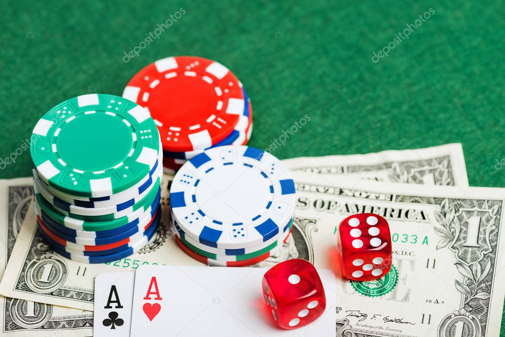 Casino green table with chips, money and dices