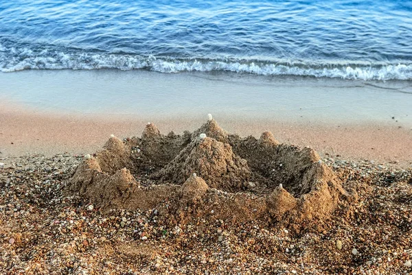 Sand castle beach wave — Stockfoto