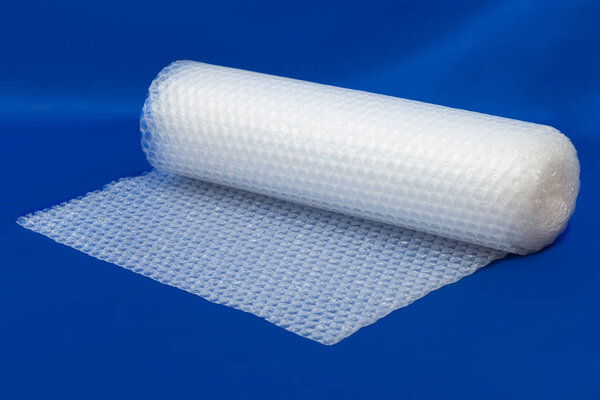Packaging bubble wrap roll on blue 