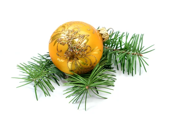 Golden Chrismas ball decoration on fir tree branches — Stock Photo, Image