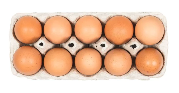 Ten Brown eggs in the cardboard package box top view isolated on — Stockfoto