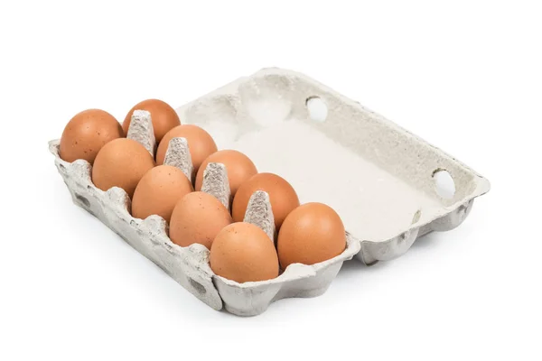 Diez huevos marrones en la caja de cartón vista de ángulo alto isol — Foto de Stock