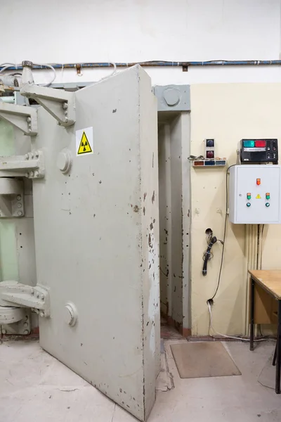 Armored door with a symbol of radiation hazard