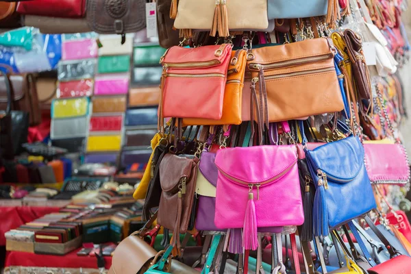 Multicolored bags and wallets on the market in Florence, Italy