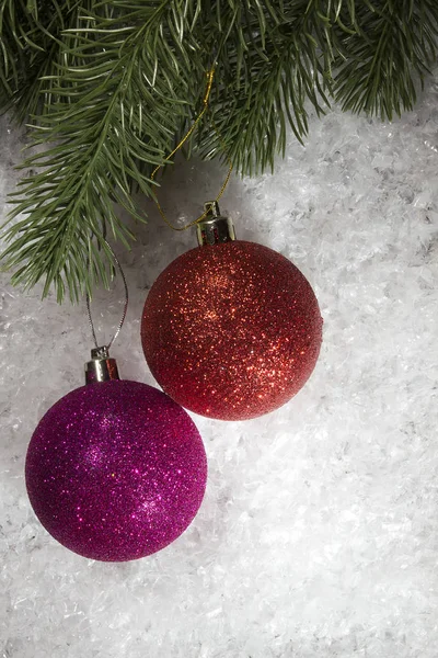 Balls and fir branch on snow — Stock Photo, Image