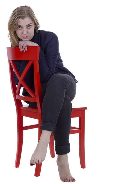 Girls on the red chair — Stock Photo, Image