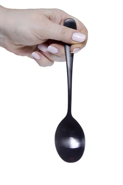 Mano femminile con un cucchiaio — Foto Stock