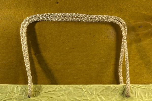 Rope handles from a paper bag