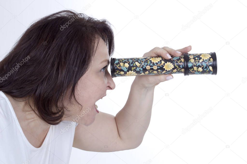 Adult woman looking into a kaleidoscope