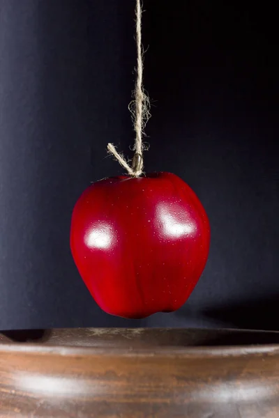 Apple on the rope is lowered into a pot — Stock Photo, Image