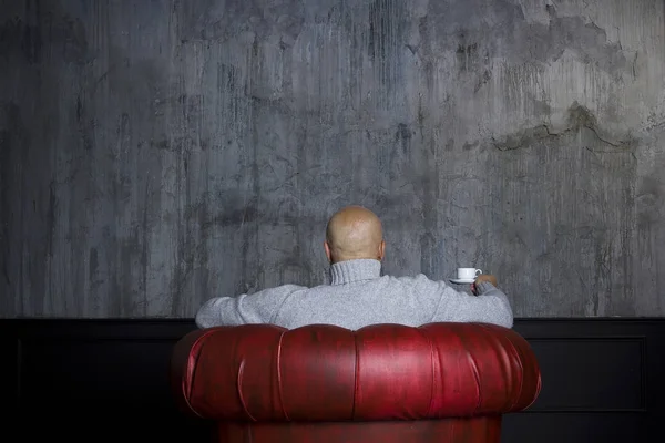 Bald man in the red armchair — Stock Photo, Image