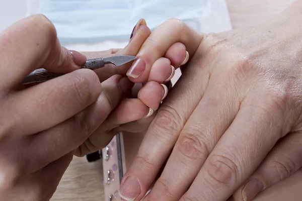 Manicure specialist care by finger nail. — Stock Photo, Image