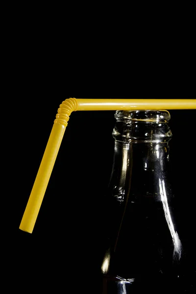 The neck of a cola bottle with a straw — Stock Photo, Image