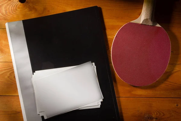 Folder with photos and tennis racket — Stock Photo, Image