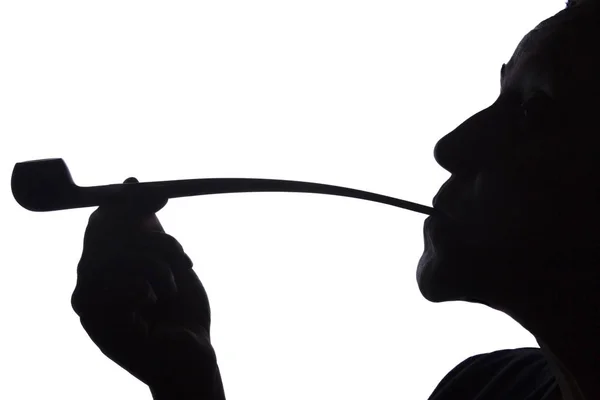 Silhouette of a woman smoking a pipe — Stock Photo, Image