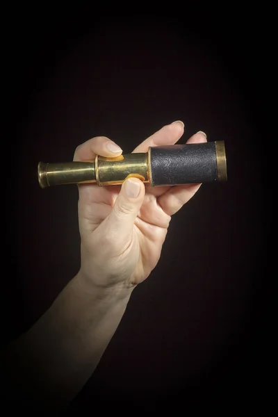 Hand holds spyglass — Stock Photo, Image