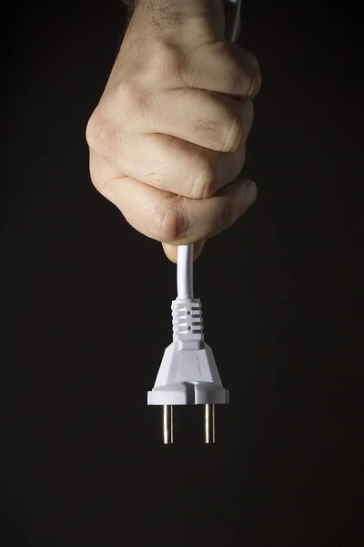 Hand with cord and plug — Stock Photo, Image