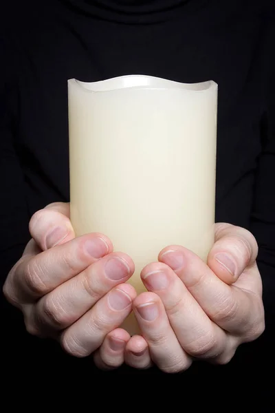 Hands with a candle — Stock Photo, Image