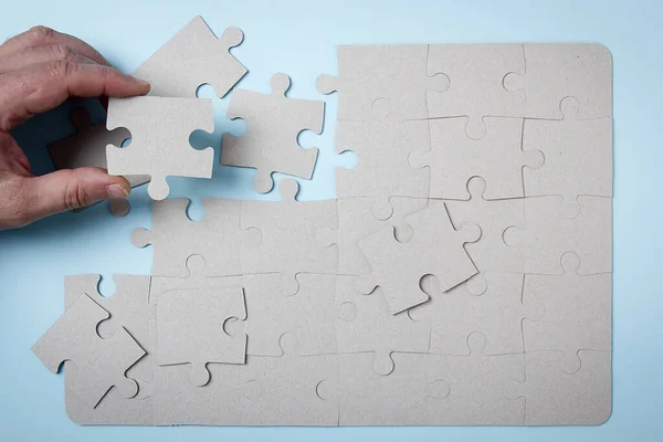 Hand Puts Puzzle Blue Background — Stock Photo, Image