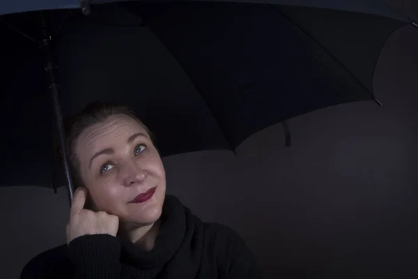 Vrouw Onder Een Zwarte Paraplu Een Donkere Achtergrond — Stockfoto