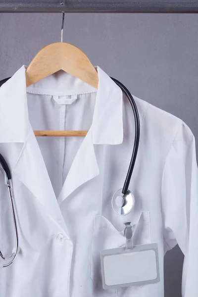 Doctor`s white coat and stethoscope on a hanger