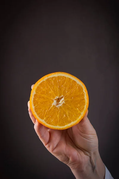 Female Hand Orange Black Background — Stock Photo, Image