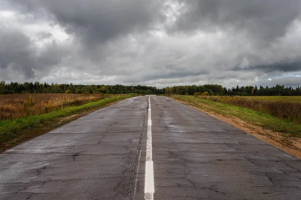Old wet asphalt road after rain — Stock Photo, Image