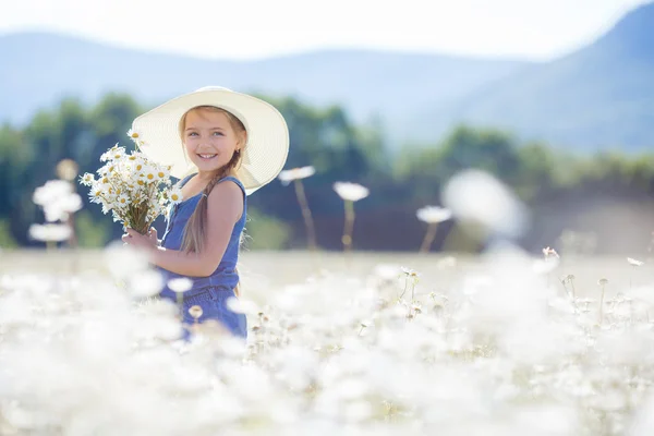 Summer portrait of a little girl in a field of white daisies. — Stock Photo, Image