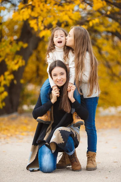 Three sisters on walk in autumn Park — Stock Photo, Image