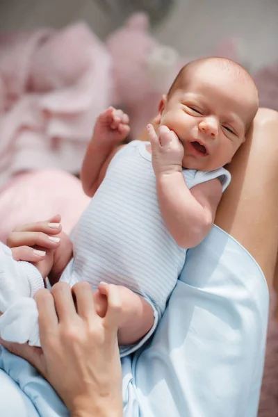 Newborn baby lying on his mother's lap — Stock Photo, Image