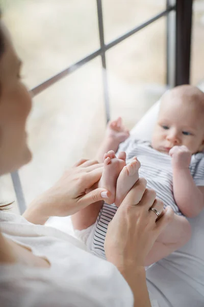 Newborn baby lying on his mother's lap — Stock Photo, Image